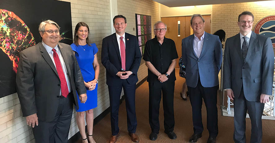 Deputy Assistant Secretary Dennis Alvord, EDA Regional Director Jorge Ayala, Congressman Mike Cloud and leaders from the University of Texas at Austin gather following the $5 million EDA grant announcement